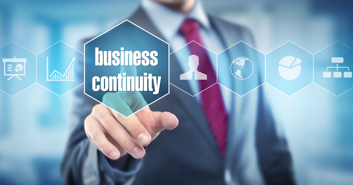 An image of a man touching a business continuity icon.