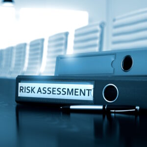 An image of a binder labeled "risk assessment.