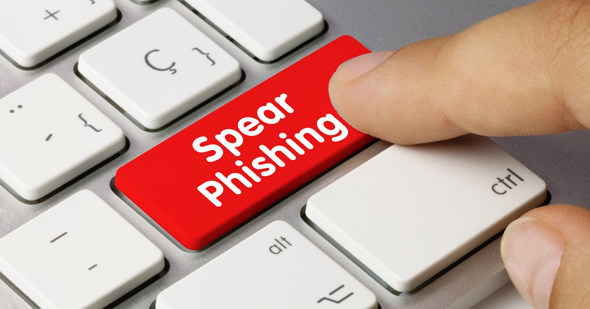 An image of a finger pressing a red button that reads "Spear Phishing."