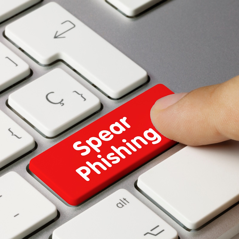 An image of a finger pressing a red button that reads "Spear Phishing."