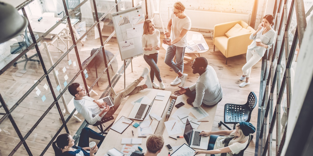 An image of a team of workers collaborating in an office.