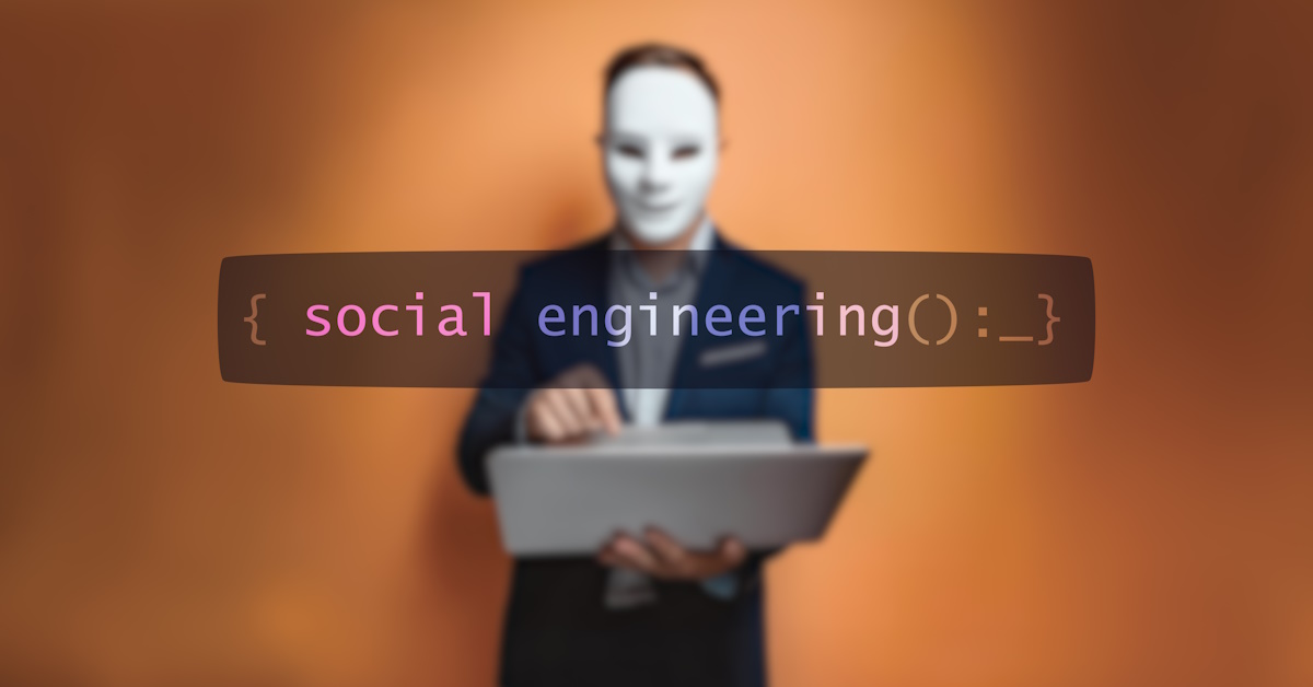 An image of a blurred hacker/scammer with a white mask on in the background, and the word "social engineering" in the foreground.