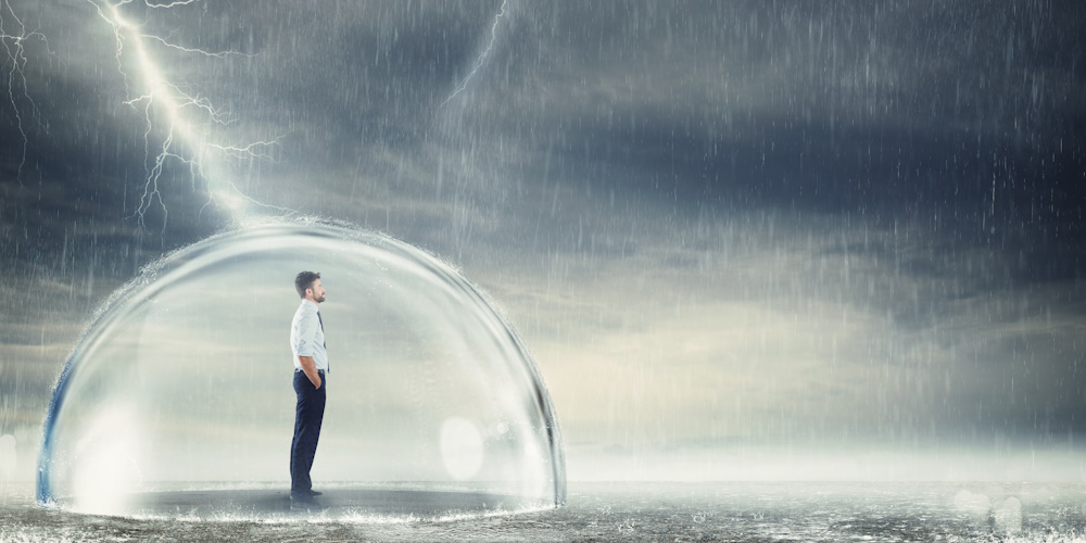 An image of a man standing in a storm but it protected by a bubble around him.