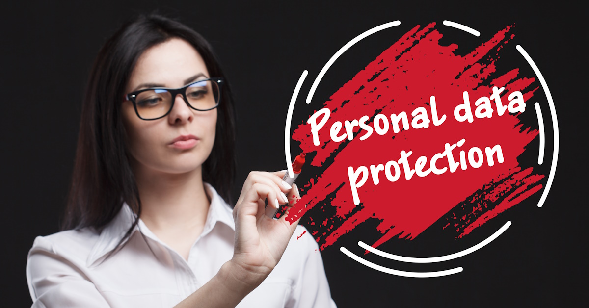 An image of a woman using a marker to draw an picture that reads "personal data protection."