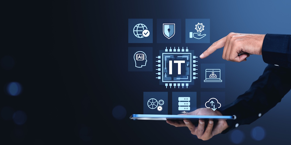An image of a person holding a tablet with an image projecting from the tablet containing different icons, on of which reads "IT."