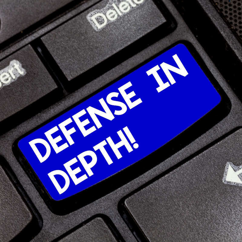 an image of a keyboard with a button that reads "defense in depth".